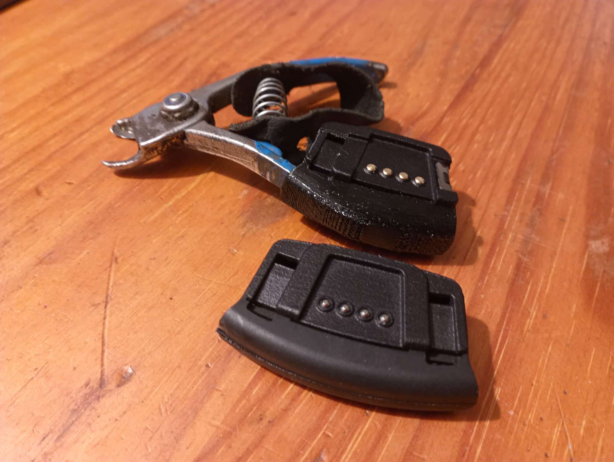 The newest enclosure (on the scissors) and the initial V2 design.